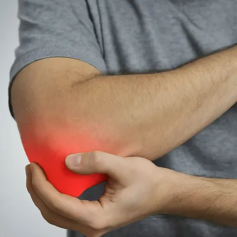 Person holding a painful elbow, illustrating elbow and wrist pain treatment