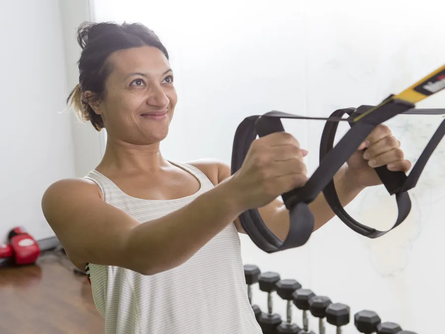 Client training with suspension straps during a personal training session at Active Performance Clinic