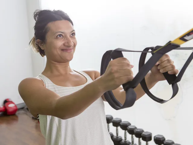 Client training with suspension straps during a personal training session at Active Performance Clinic