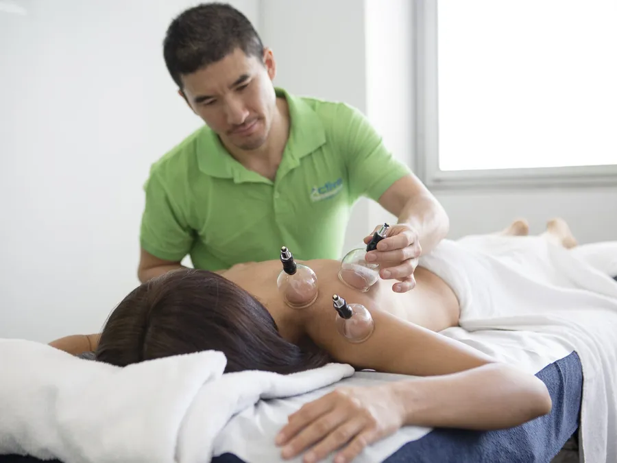 Practitioner applying cupping during a recovery session at Active Performance Clinic